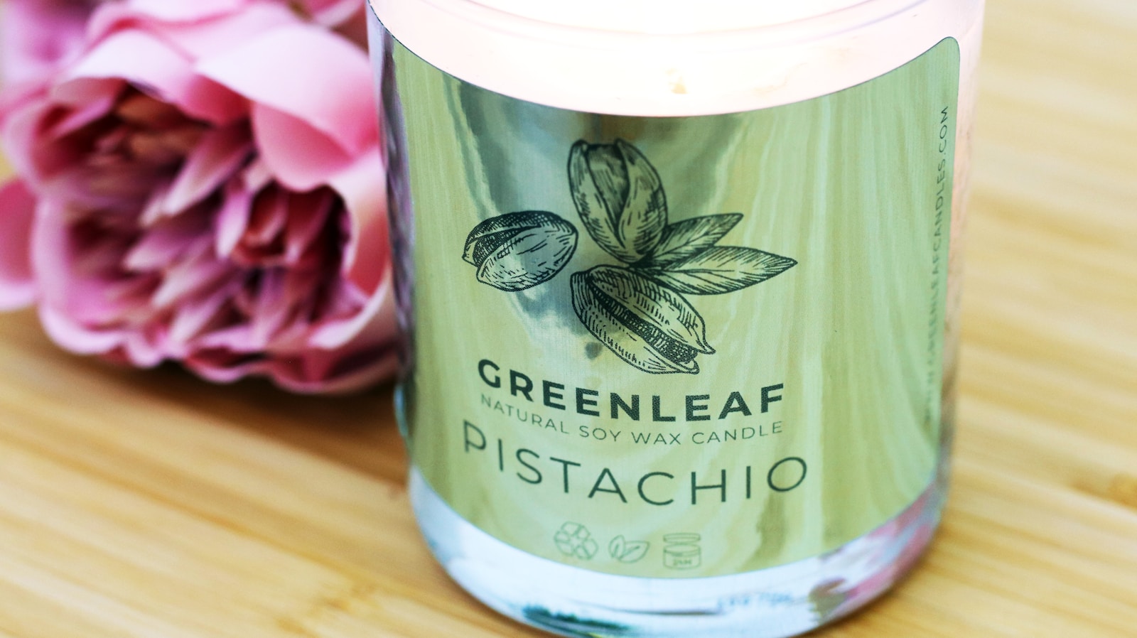 Custom full-color label freshly bonded to a candle jar at a launch gifting station