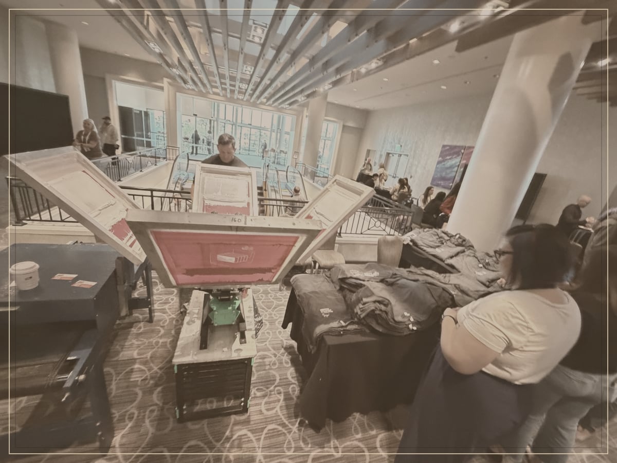 Wide view of a holiday party floor with live printing stations running